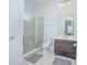 Modern bathroom with a glass-enclosed shower, and a dark vanity with countertop sink at 7831 Dausset St, Orlando, FL 32827