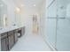 Bright bathroom features double vanity, walk-in glass shower, and walk-in closet at 7831 Dausset St, Orlando, FL 32827