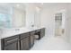 Well-lit bathroom features a double vanity with marble countertop and open access to a walk-in closet at 7831 Dausset St, Orlando, FL 32827
