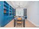 Chic dining room offers modern light fixtures and custom blue shelving at 7831 Dausset St, Orlando, FL 32827