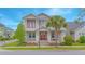 Charming two-story home with a welcoming front porch and beautiful landscaping at 7831 Dausset St, Orlando, FL 32827
