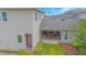 Exterior view of home with covered patio, showcasing an outdoor living and dining area at 7831 Dausset St, Orlando, FL 32827
