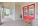 Charming home exterior showcasing a vibrant red double front door and brick-paved entryway at 7831 Dausset St, Orlando, FL 32827
