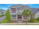 Charming two-story home with red doors, a manicured lawn, and a mature palm tree in a desirable neighborhood at 7831 Dausset St, Orlando, FL 32827