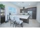 Stylish kitchen with stainless steel appliances, large island with seating and granite countertops at 7831 Dausset St, Orlando, FL 32827