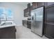Modern kitchen featuring stainless steel appliances, sleek countertops, and dark wood cabinets at 7831 Dausset St, Orlando, FL 32827