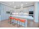Bright kitchen featuring a central island with seating, quartz countertop, and stainless steel appliances at 7831 Dausset St, Orlando, FL 32827
