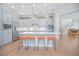 Spacious open kitchen with large island, seating, modern lighting, and seamless connection to living area at 7831 Dausset St, Orlando, FL 32827