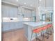 Open kitchen showcasing a central island with seating, pendant lighting, and modern stainless steel appliances at 7831 Dausset St, Orlando, FL 32827