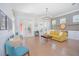 Bright living room boasts hardwood floors, modern lighting, and stylish decor at 7831 Dausset St, Orlando, FL 32827