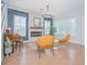 Bright living room featuring fireplace, modern chairs, and hardwood floors at 7831 Dausset St, Orlando, FL 32827