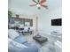 Open-concept living room with modern furnishings flowing into a kitchen with stainless steel appliances at 7831 Dausset St, Orlando, FL 32827