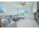 Comfortable living room boasts a large sectional sofa, a ceiling fan, and ample natural light at 7831 Dausset St, Orlando, FL 32827