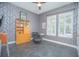 Stylish office featuring modern decor, statement wallpaper, and herringbone tile flooring at 7831 Dausset St, Orlando, FL 32827