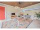 Inviting outdoor living space with ceiling fan, stone floors, dining set, and entertainment area at 7831 Dausset St, Orlando, FL 32827