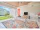 Inviting outdoor living space with dining set, ceiling fan, and entertainment area at 7831 Dausset St, Orlando, FL 32827