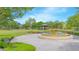 Beautiful park featuring a tranquil fountain, lush greenery, benches, and picturesque landscaping at 7831 Dausset St, Orlando, FL 32827