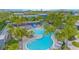 A resort-style pool area with lush landscaping, a slide, and lounge chairs, perfect for relaxing and enjoying community amenities at 7831 Dausset St, Orlando, FL 32827