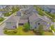Aerial view of a home featuring a stone patio and a well-maintained backyard within a residential community at 7831 Dausset St, Orlando, FL 32827