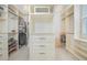 Walk-in closet with custom shelving and ample storage space, lit by decorative lighting at 7831 Dausset St, Orlando, FL 32827