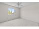 Bright bedroom with a ceiling fan and a window providing natural light and neighborhood views at 905 Ocala Woods Ln, Orlando, FL 32824