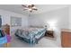 Bright bedroom featuring a ceiling fan, a large window, and cozy carpeting at 905 Ocala Woods Ln, Orlando, FL 32824