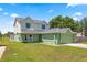 Charming two-story home with a well-manicured lawn, and a three car garage at 905 Ocala Woods Ln, Orlando, FL 32824