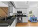 Updated kitchen with granite countertops, stainless steel appliances, white cabinetry, and hardwood floors at 905 Ocala Woods Ln, Orlando, FL 32824