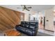 Open-concept living room with wood-panelled accent wall flowing into the kitchen and dining area at 905 Ocala Woods Ln, Orlando, FL 32824