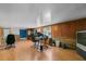 Spacious office with wood paneling, laminate flooring, and a variety of furniture and lighting at 905 Ocala Woods Ln, Orlando, FL 32824