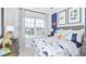 bedroom with dinosaur decor, comfortable bed, and large window at 1048 Teal Creek St, St Cloud, FL 34771