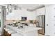 Bright kitchen features an island with seating, stainless steel appliances, and white cabinets at 1048 Teal Creek St, St Cloud, FL 34771