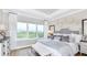 Bright main bedroom features plush carpet, large window, and neutral decor at 1048 Teal Creek St, St Cloud, FL 34771