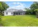 Expansive backyard with a screened-in pool area and well-maintained lawn at 11014 Hawkshead Ct, Windermere, FL 34786