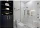 Clean bathroom featuring a modern vanity, built-in shelving, toilet and glass enclosed shower at 11014 Hawkshead Ct, Windermere, FL 34786