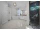 Spacious primary bathroom featuring dual vanity, soaking tub, glass shower, and luxurious marble flooring at 11014 Hawkshead Ct, Windermere, FL 34786