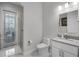 Well-lit bathroom with a modern vanity, toilet, and glass-enclosed shower for a clean aesthetic at 11014 Hawkshead Ct, Windermere, FL 34786