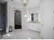 Elegant bathroom with a modern vanity, stylish lighting, and marble floors for a luxurious feel at 11014 Hawkshead Ct, Windermere, FL 34786