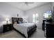 Comfortable bedroom with a queen-sized bed, plush carpeting, and a window with plantation shutters at 11014 Hawkshead Ct, Windermere, FL 34786