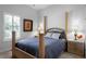 Comfortable bedroom with four poster bed, plantation shutters, and dual nightstands at 11014 Hawkshead Ct, Windermere, FL 34786