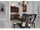 Dining room with classic wood furniture, wet bar, chandelier, and marble floors at 11014 Hawkshead Ct, Windermere, FL 34786