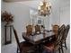 Formal dining room with marble floors, a statement chandelier, and a large wood dining table at 11014 Hawkshead Ct, Windermere, FL 34786