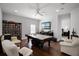Spacious game room featuring a pool table, media center, and comfortable seating area at 11014 Hawkshead Ct, Windermere, FL 34786