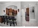 An open kitchen with marble floors, dark wood cabinets, breakfast bar, and a view to the staircase at 11014 Hawkshead Ct, Windermere, FL 34786