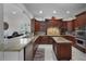 Gourmet kitchen with custom wood cabinetry, granite counters, central island, and stainless steel appliances at 11014 Hawkshead Ct, Windermere, FL 34786