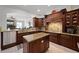 Gourmet kitchen with granite countertops, center island, custom cabinets and stainless steel appliances at 11014 Hawkshead Ct, Windermere, FL 34786