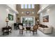 Elegant living room with tall ceilings, neutral tones, marble floors, and views of the screened-in patio at 11014 Hawkshead Ct, Windermere, FL 34786