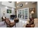 Elegant living room featuring marble floors, a piano, and neutral tones at 11014 Hawkshead Ct, Windermere, FL 34786