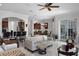 Spacious living room featuring marble floors with an open layout to the kitchen and dining area at 11014 Hawkshead Ct, Windermere, FL 34786