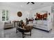 Bright living room featuring a decorative fireplace, marble floors, and a view of the kitchen at 11014 Hawkshead Ct, Windermere, FL 34786